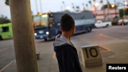 Anderson, a migrant, waits for a bus to Atlanta after being released from a detention center, in McAllen, Texas, May 9, 2017.