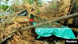 A resident retrieves belongings from his destroyed house after Typhoon Nock-Ten hit Malinao, Albay in central Philippines, Dec. 26, 2016.