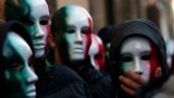 Members of Casapound far-right organization wear masks in the colors of the Italian flag before a demonstration organized by &quot;People from pitchfork movement&quot; to protest against economic insecurity and the government in downtown Rome.