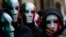 Members of Casapound far-right organization wear masks in the colors of the Italian flag before a demonstration organized by "People from pitchfork movement" to protest against economic insecurity and the government in downtown Rome.
