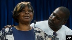 Audrey DuBose, mother of Samuel DuBose, is comforted by her son Aubrey as she speaks to the media after charges against a University of Cincinnati police officer were announced in the traffic stop shooting death of Samuel, July 29, 2015.