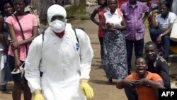 A woman reacts after her husband is suspected of dying from the Ebola virus, in the Liberian capital Monrovia, Oct. 4, 2014. 