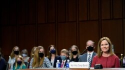 U.S. Supreme Court nominee Judge Amy Coney Barrett reacts as she sits in front of her children and her husband Jesse Barrett during the second day of her confirmation hearing before the Senate Judiciary Committee on Capitol Hill in Washington, D.C.