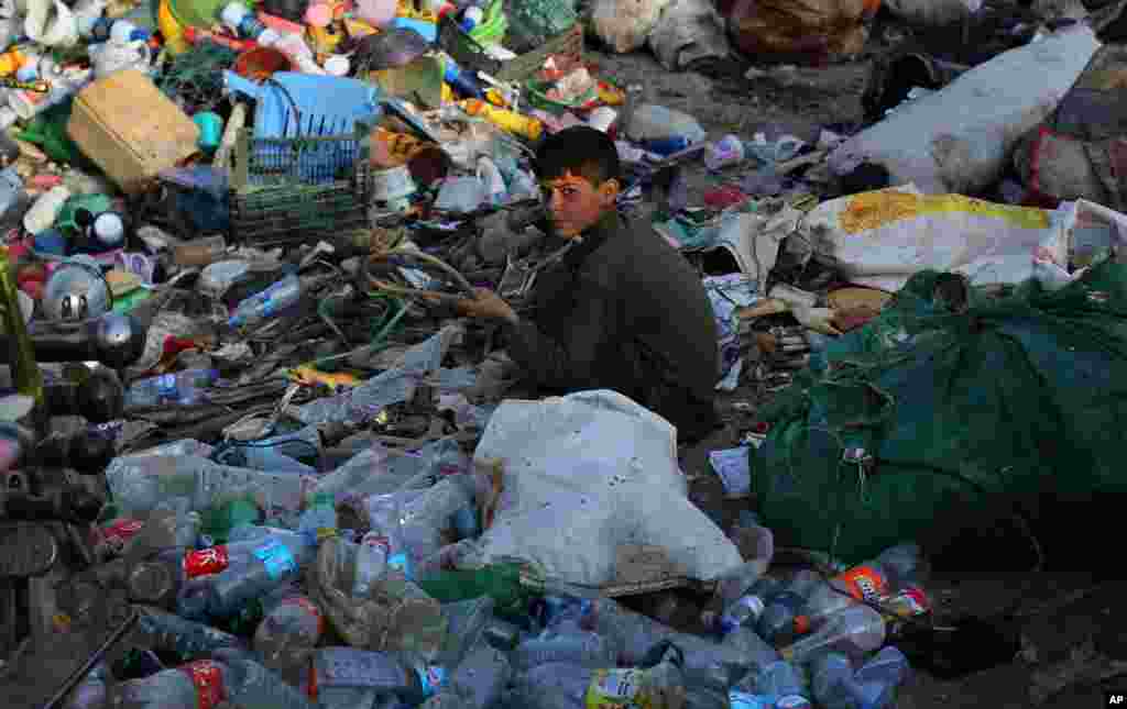 An Afghan boy sorts used plastic at a recycling unit in Kabul, Afghanistan.