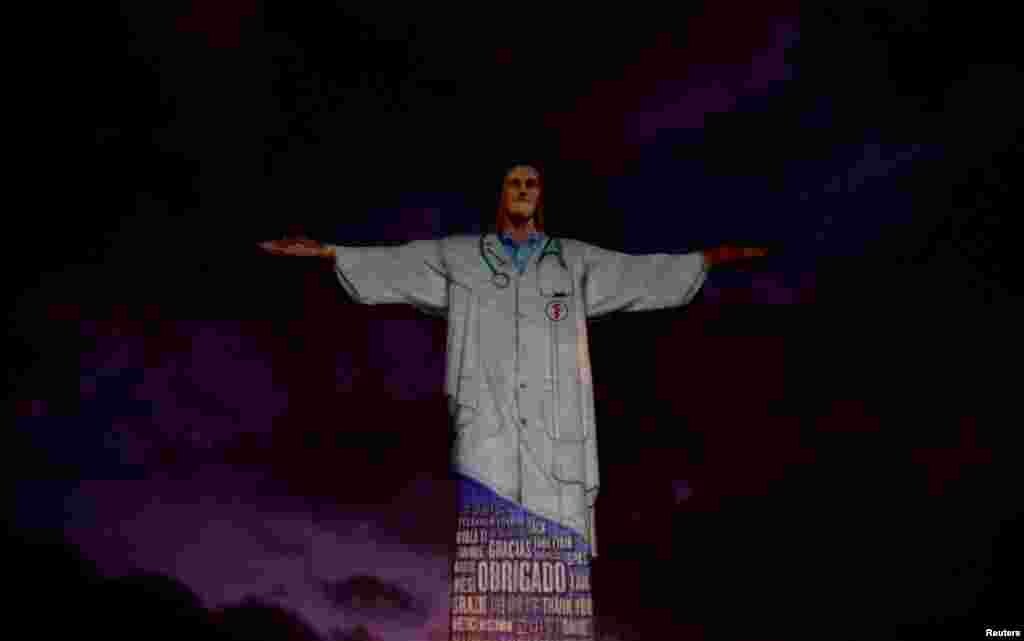 The statue of Christ the Redeemer is lit up with the image of medical clothing and the word &quot;thank you&quot; in different languages during an Easter Sunday event in Rio de Janeiro, Brazil, April 12, 2020.