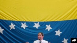 FILE - In this Sept. 30, 2019 photo, opposition leader and self-proclaimed interim President Juan Guaido speaks during a citizen assembly at a square in the neighborhood of El Paradiso in Caracas, Venezuela.