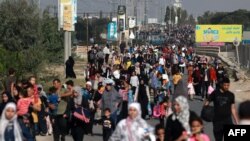 FILE - Palestinians fleeing Gaza City towards the southern areas walk on a road on November 8, 2023, amid the ongoing battles between Israel and the Palestinian Islamist group Hamas.