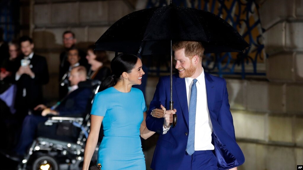 FILE - Britain's Prince Harry and Meghan arrive at the annual Endeavour Fund Awards in London, March 5, 2020. The Duke and Duchess of Sussex are expecting their second child, their office confirmed Sunday, Feb. 14, 2021.