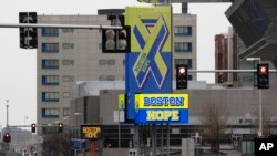 A usually busy Summer Street runs past signs for the Boston Hope field hospital at the Convention Center, during the coronavirus pandemic, April 24, 2020, in Boston. 
