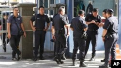 Police officers stand near the entrance of the forensic department at the hospital in Kuala Lumpur, Malaysia, Feb. 16, 2017. Kim Jong Nam told medical workers before he died that he had been attacked with a chemical spray, a Malaysian official said Tuesda