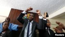 A policeman leads the handcuffed officials of the Kenya Medical Practitioners, Pharmacists and Dentist Union (KMPDU), after their case to demand fulfilment of a 2013 agreement between their union and the government, at the employment and labor relations courts in Nairobi, Kenya, Feb. 13, 2017.