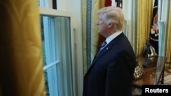U.S. President Donald Trump looks out a window of the Oval Office following an interview with Reuters at the White House in Washington, April 27, 2017.