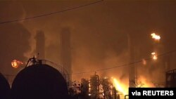 Flames rise over a petrochemical plant after an explosion in a still image from video in Port Neches, Texas, U.S., Nov. 27, 2019.