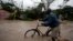 FILE - A man pushes a bicycle through flood waters after Hurricane Matthew passed through Les Cayes, Haiti, Oct. 4, 2016. 