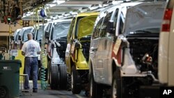 A General Motors employee works on a van assembly line at GM's plant in Wentzville, Missouri, November 3, 2011.