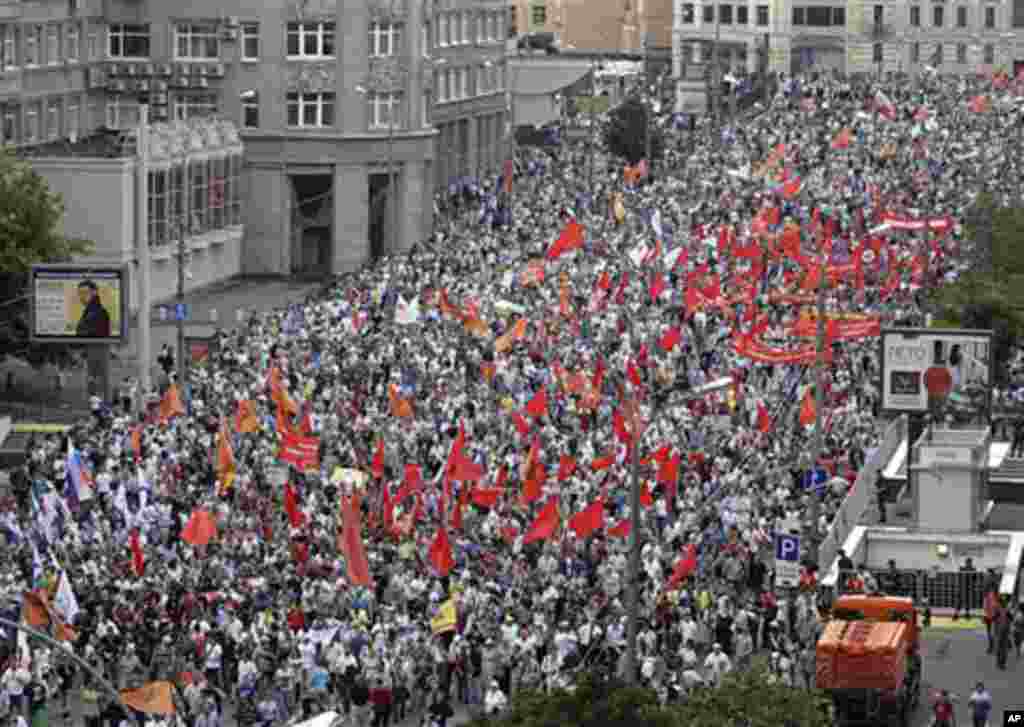 Demonstrators hold the flags of various groups during a massive protest against Putin's rule in Moscow, Tuesday, June 12, 2012. Thousands of Russians are gathering Tuesday for the first massive protest against President Vladimir Putin's rule since his ina