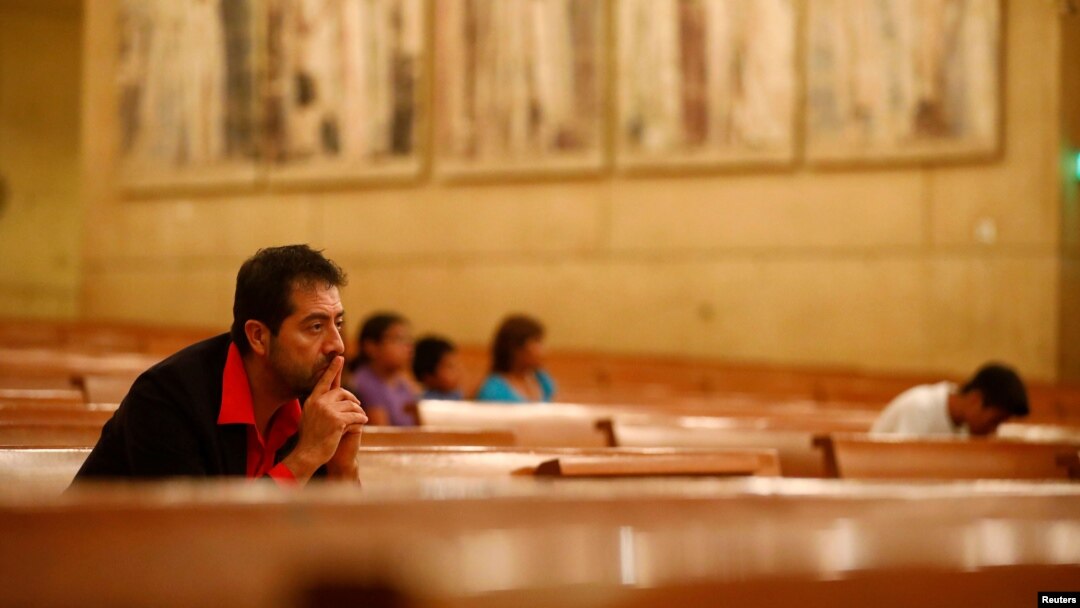 Ernesto Vega, of the archdiocese of Los Angeles Hispanic ministry, listens as Los Angeles Catholic Archbishop Jose Gomez leads an interfaith prayer service for the immigrant community following the election of Republican Donald Trump, in Los Angeles, California, Nov. 10, 2016.