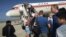 FILE - passengers board an Air Koryo plane bound for Beijing, at the Pyongyang International Airport in Pyongyang, North Korea. 