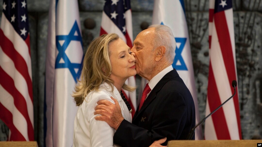 ARSIP - Mantan Menlu AS, Hillary Clinton, kiri dan Shimon Peres, berpelukan setelah mengeluarkan pernyataan bersama (16/7/2012). (foto: AP Photo/Oded Balilty).