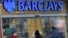 Customers wait outside a retail branch of Barclays Bank for the bank to open in London, Feb. 12, 2013.