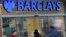 Customers wait outside a retail branch of Barclays Bank for the bank to open in London, Feb. 12, 2013.