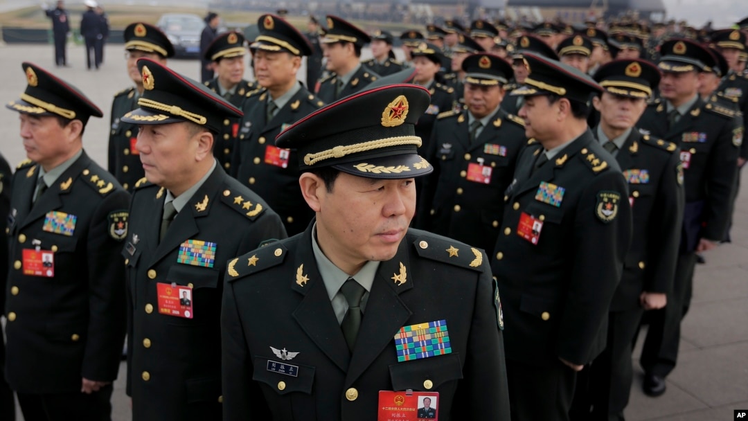 Delegates from China's People's Liberation Army (PLA) stand in line as they arrive at the Great Hall of the People to attend a session of National People's Congress in Beijing, March 4, 2016.