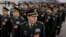 Delegates from China's People's Liberation Army (PLA) stand in line as they arrive at the Great Hall of the People to attend a session of National People's Congress in Beijing, March 4, 2016.
