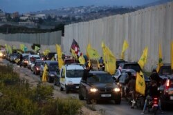 Supporters of Lebanon's Hezbollah leader Sayyed Hassan Nasrallah ride in a convoy in the village of Kfar Kila, near the border with Israel, southern Lebanon, Oct. 25, 2019.