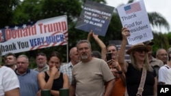 White South Africans demonstrate in support of U.S. President Donald Trump in front of the U.S. embassy in Pretoria, South Africa, Saturday, Feb. 15, 2025. (AP Photo/Jerome Delay)