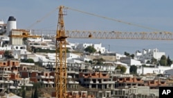 A crane is seen over an abandoned tourist resort construction in Gale on the southern Portuguese province of Algarve, March 6, 2012.