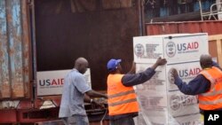 American Aid goods are loaded onto a truck after it arrived by airplane, to be used in the fight against the Ebola virus spreading in the city of Monrovia, Liberia, Aug. 24, 2014. 