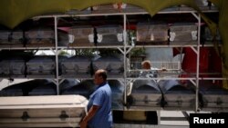 Vendors carry a coffin to deliver it to a funeral home as the coronavirus outbreak continues, in Ciudad Juarez, Mexico, May 19, 2021. 