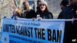 A group of Sept. 11 families and supporters rally during a news conference, Feb. 16, 2017, in New York. Group spokesman John Sigmund, who lost his sister Johanna Sigmund in the Sept. 11 attacks, said the group "9/11 Families and Friends United Against the Ban," came together two weeks ago to speak "out against this deplorable Muslim ban that was in the recent executive order by President Trump."