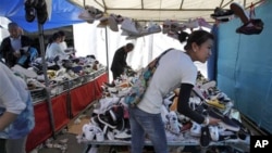 Shoppers hunt for bargain shoes at a market in Beijing, China. China's consumer prices rose 5.4 percent over a year ago, driven by 11.7 percent surge in food costs, April 15, 2011