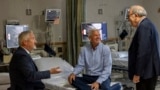 In this photo provided by Massachusetts General Hospital, patient Mike Garrity, center, speaks with Drs. Joe Garasic, left, and Randy Zusman in Boston, on Sept. 25, 2024. (Jeffrey Andree/Massachusetts General Hospital via AP)