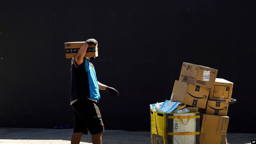 FILE - In this photo taken Feb. 5, 2019, a woman works at a distribution Amazon fulfillment center in Staten Island, one of the five boroughs of New York City.