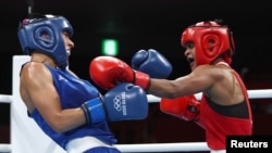 Ramla Said Ahmed Ali of Somalia in action against Claudia Nechita of Romania in women's featherweight boxing in Tokyo, Japan, July 26, 2021.