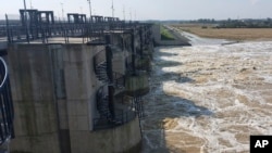 This photo provided by the state company Polish Waters shows the Oder River flood waters channeled into the newly-built Lower Raciborz Reservoir in Raciborz, southwestern Poland, Sept. 23, 2024. (Polish Waters via AP)