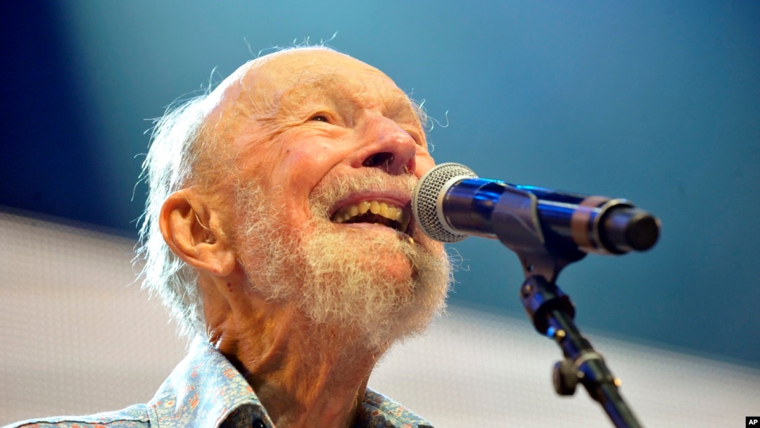 FILE - Pete Seeger performing on stage during the Farm Aid 2013 concert at Saratoga Performing Arts Center in Saratoga Springs, N.Y.