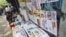A girl selling weekly journals waits for customers in Rangoon, Burma, April 2, 2012. 