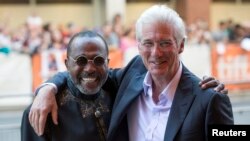 Richard Gere hugs Ben Vereen, right, as they arrive for the "Time Out of Mind" gala at the Toronto International Film Festival, Ontario, Canada, Sept. 7, 2014.