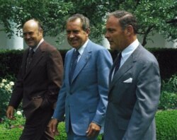 FILE - President Richard M. Nixon with Secretary of Defense Melvin Laird, and States Secretary of State Alexander Haig, walking in rose garden of the White House in Washington, June 6, 1973.