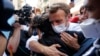 French President Emmanuel Macron hugs a resident as he visits a devastated street of Beirut to offer French support to Lebanon after the deadly port blast.