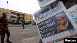 FILE - A man looks at newspapers at a newsstand in Abuja, Nigeria, June 5, 2021. 