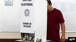 A man casts his vote during the municipal elections first round at a polling station in Sao Paulo, Brazil, Oct. 6, 2024. 