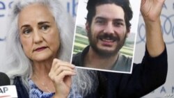 FILE - Debra Tice, mother of U.S. journalist Austin Tice, who was kidnapped in Syria five years prior, holds a dated portrait of him during a press conference in the Lebanese capital, Beirut, on July 20, 2017.