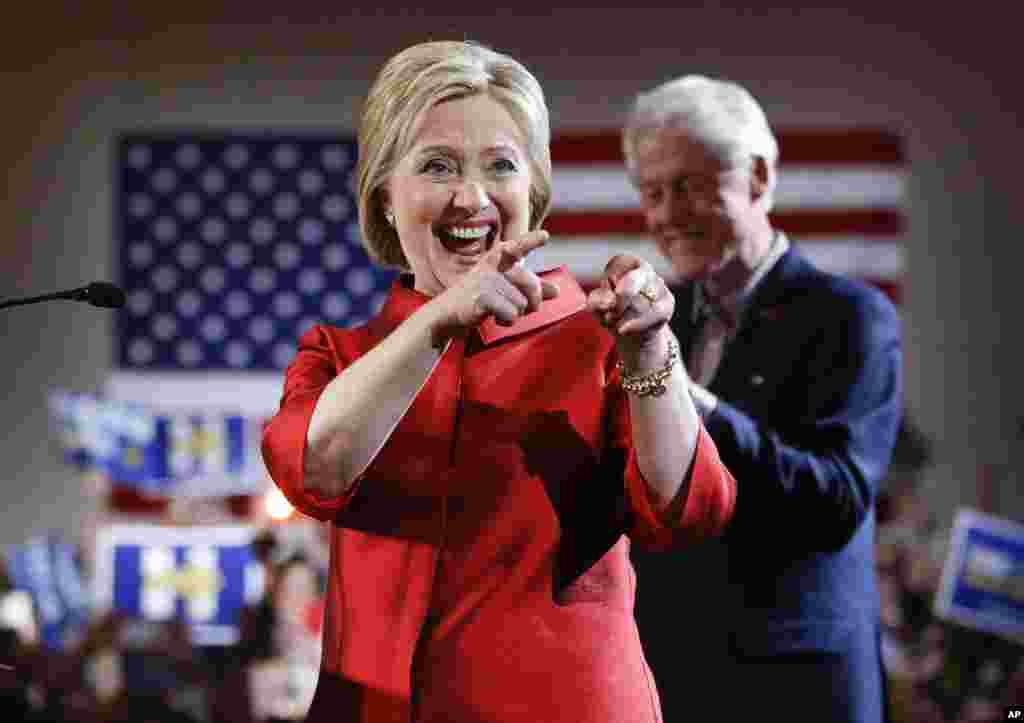Democratic presidential candidate Hillary Clinton greets supporters with her husband, former President Bill Clinton, at a Nevada Democratic caucus rally in Las Vegas, Feb. 20, 2016.