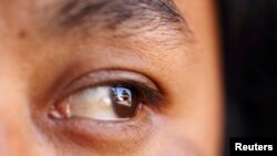 FILE - A temple is reflected in the eye of a visitor as he visits Basantapur Durbar Square in Kathmandu April 6, 2011. REUTERS/Navesh Chitrakar 