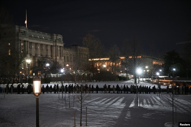 Members of the public line up near the Visitor Center entrance to view the flag-draped casket of former U.S. President Jimmy Carter, as he lies in state in the U.S. Capitol Rotunda in Washington, Jan. 8, 2025.