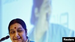 FILE - India's Foreign Minister Sushma Swaraj smiles while addressing the India Africa business forum in New Delhi, India, Oct. 28, 2015. 